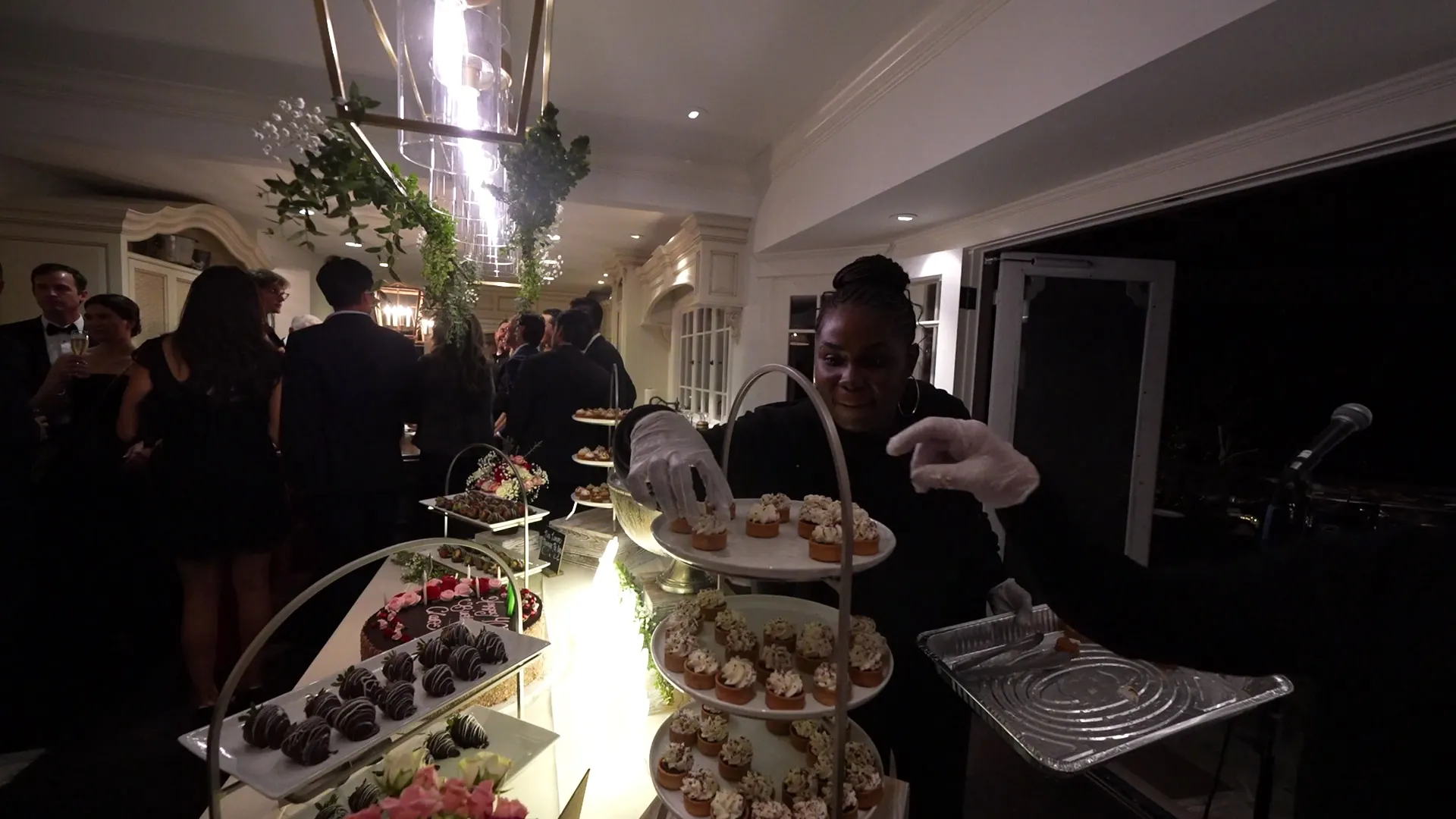 Uniformed server presenting a dessert tray at a Hillsborough estate party