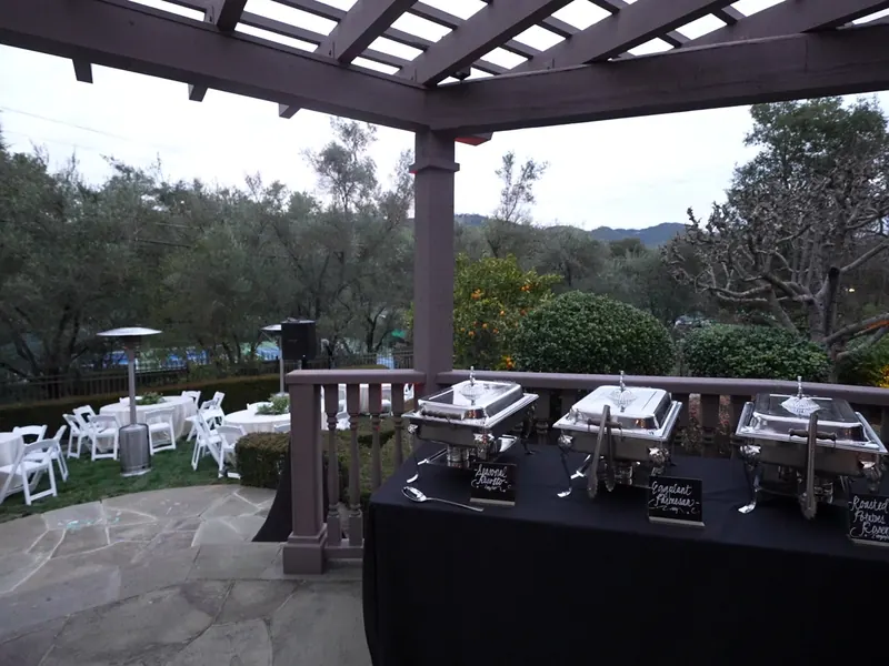 Tables set under a pergola on the lawn for a Millbrae dinner