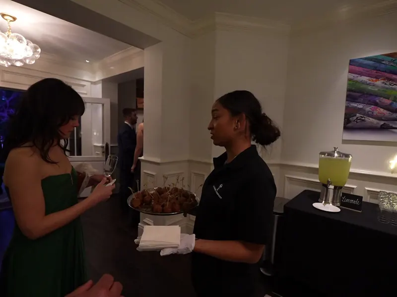 Attendant offering a tray of bites to guests at a Pacifica event