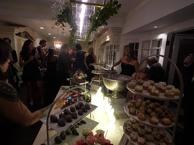 Guests gathered around a dessert display at a Foster City evening party