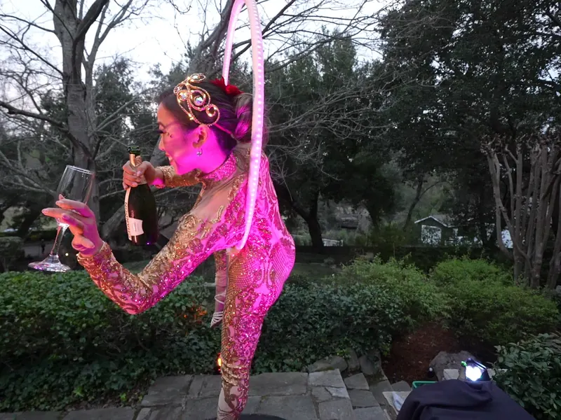 Performer entertaining guests in the garden at a Half Moon Bay celebration