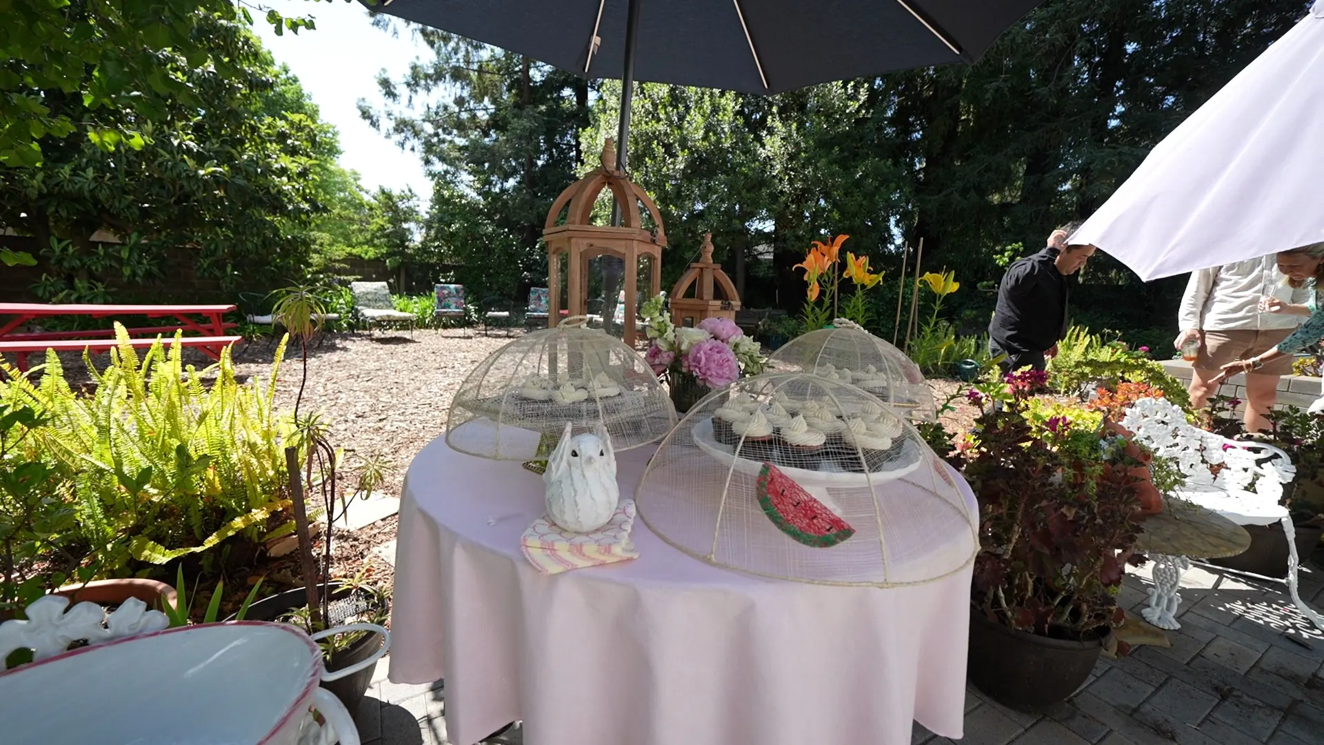 Tiered dessert stand set up in a Belmont garden before guests arrive