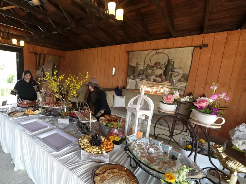 Attendant finishing a grazing table before a Millbrae party near El Camino Real
