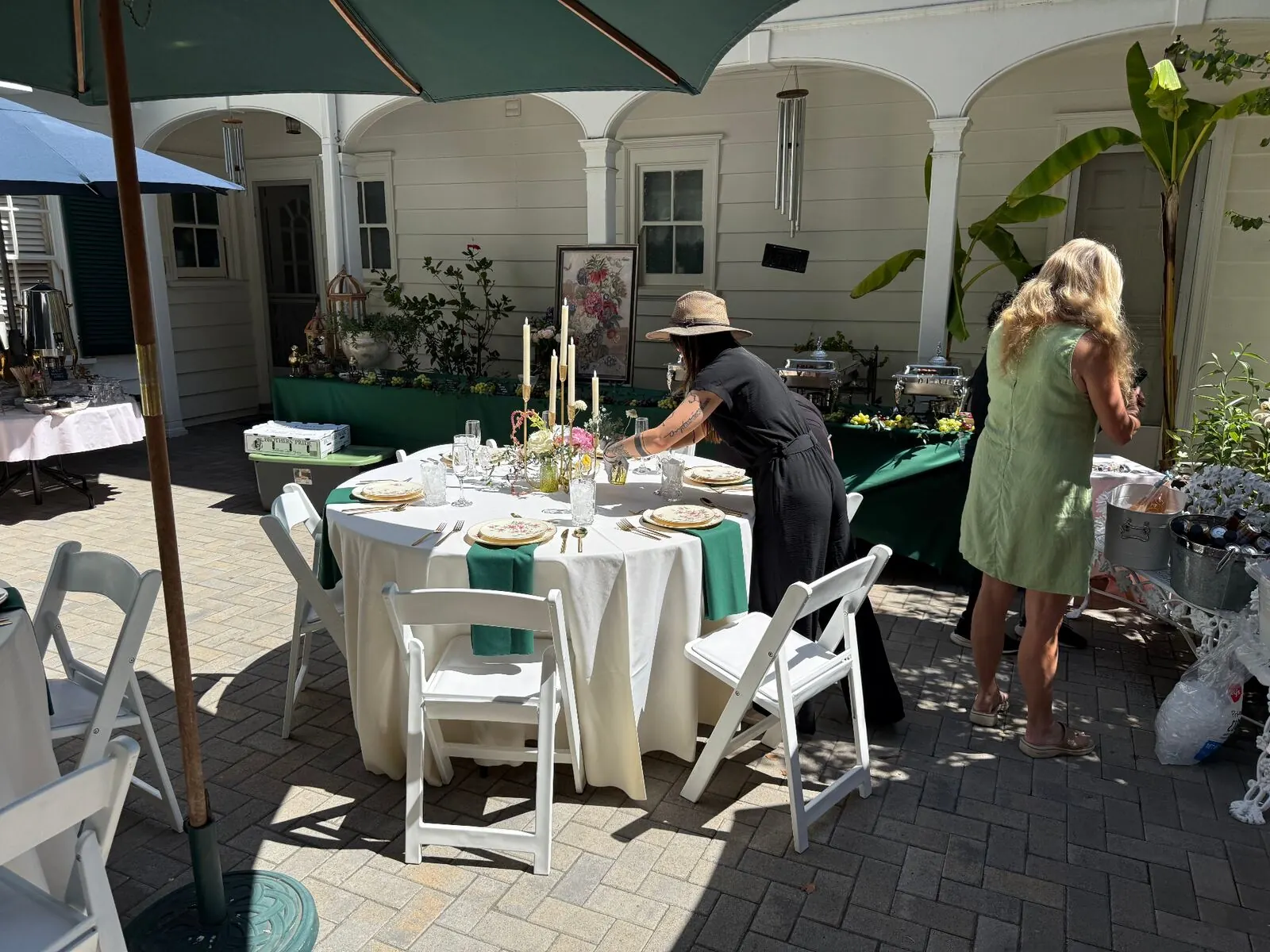 Courtyard dinner setup with linen-draped tables and string lighting at a Burlingame venue by San Mateo Catering Company