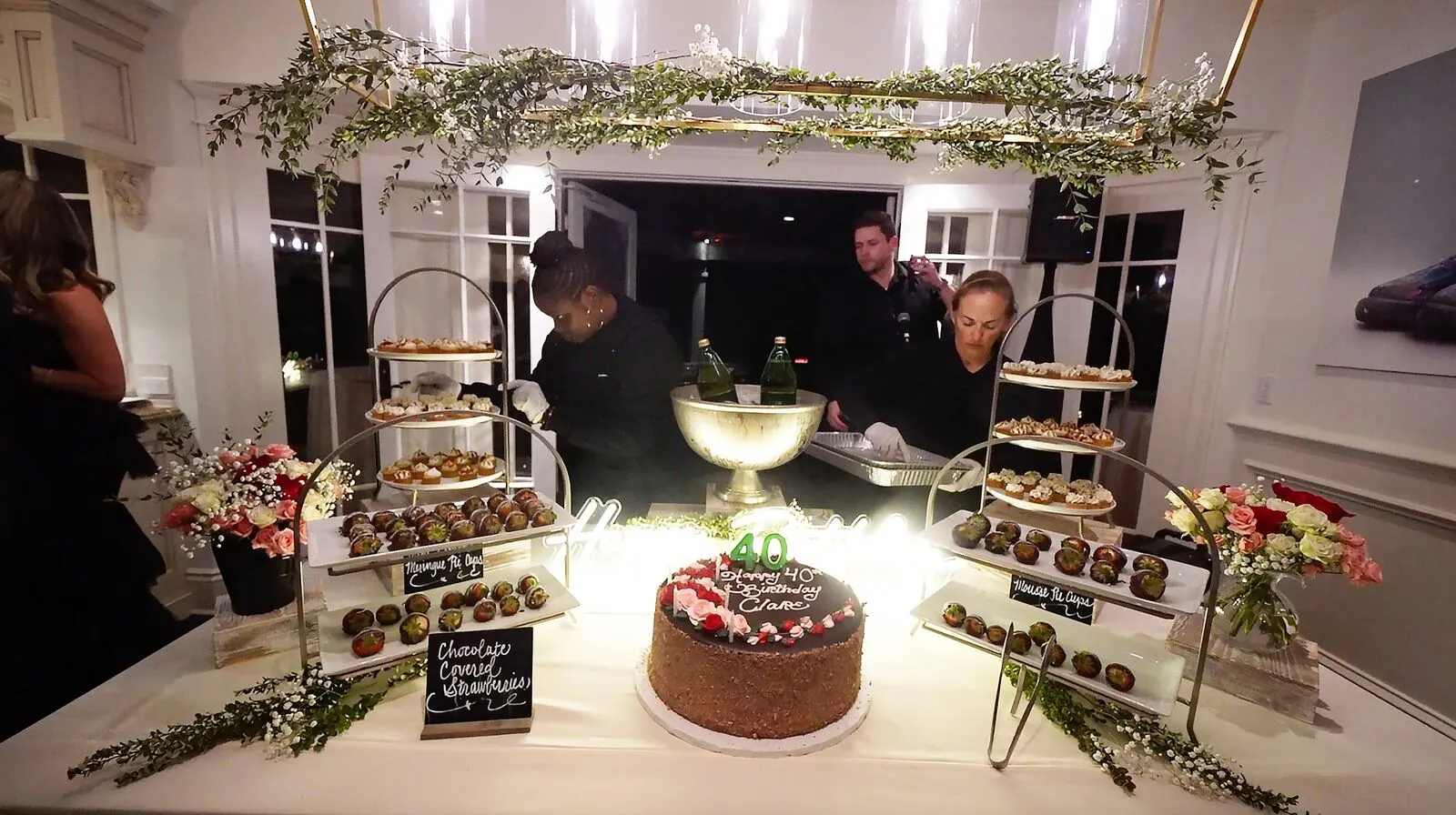 Dessert table of mini pastries, tarts and chocolate-dipped strawberries at a San Mateo celebration by San Mateo Catering Company