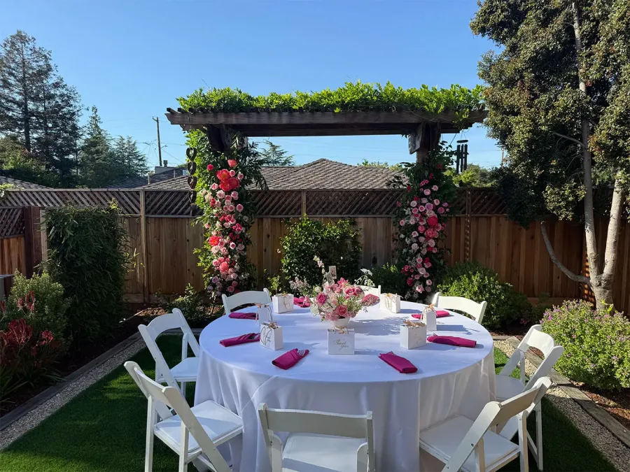 In-house floral arch of blooms and greenery framing a ceremony space at a San Mateo County wedding by San Mateo Catering Company